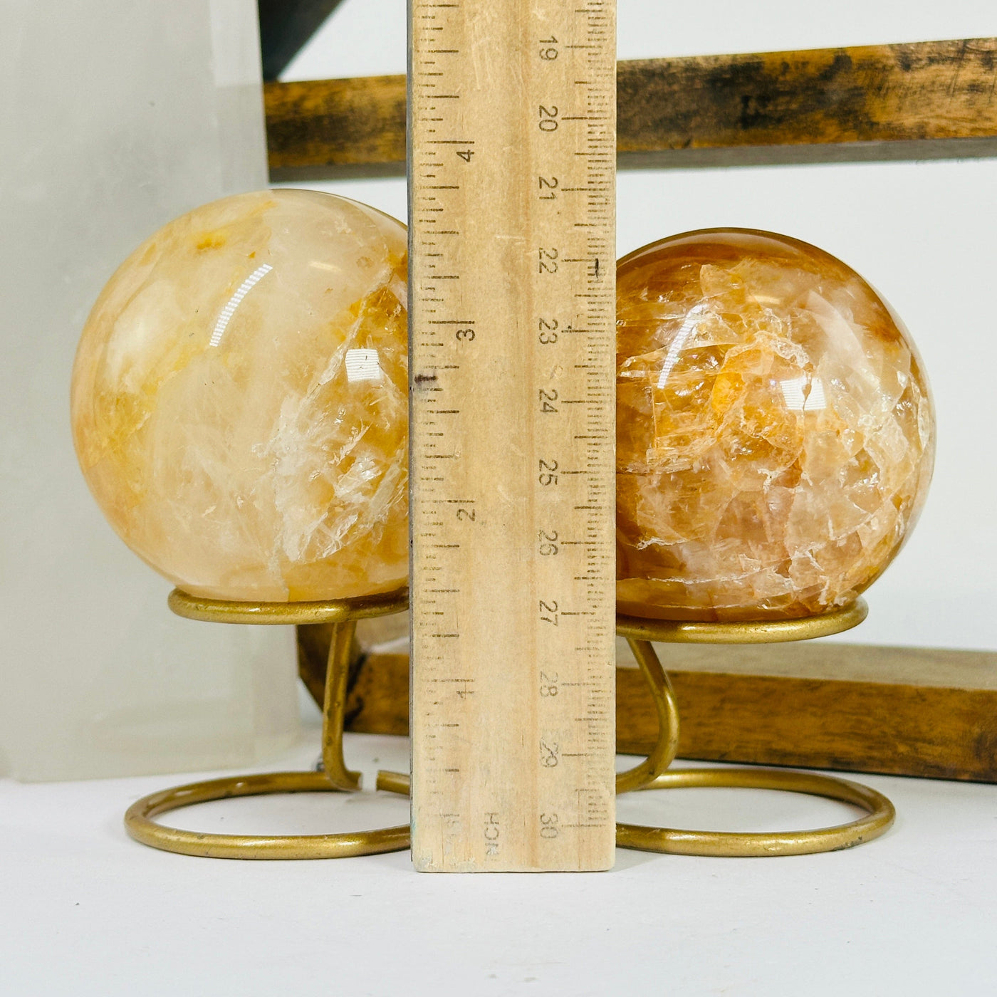 golden healer sphere next to a ruler for size reference