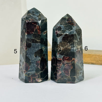 hematite point with decorations in the background