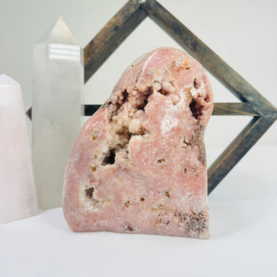 pink amethyst cut base with decorations in the background