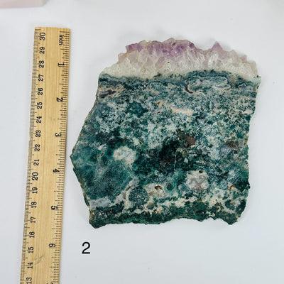 amethyst slabs next to a ruler for size reference