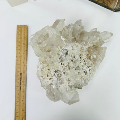 crystal quartz cluster next to a ruler for size reference