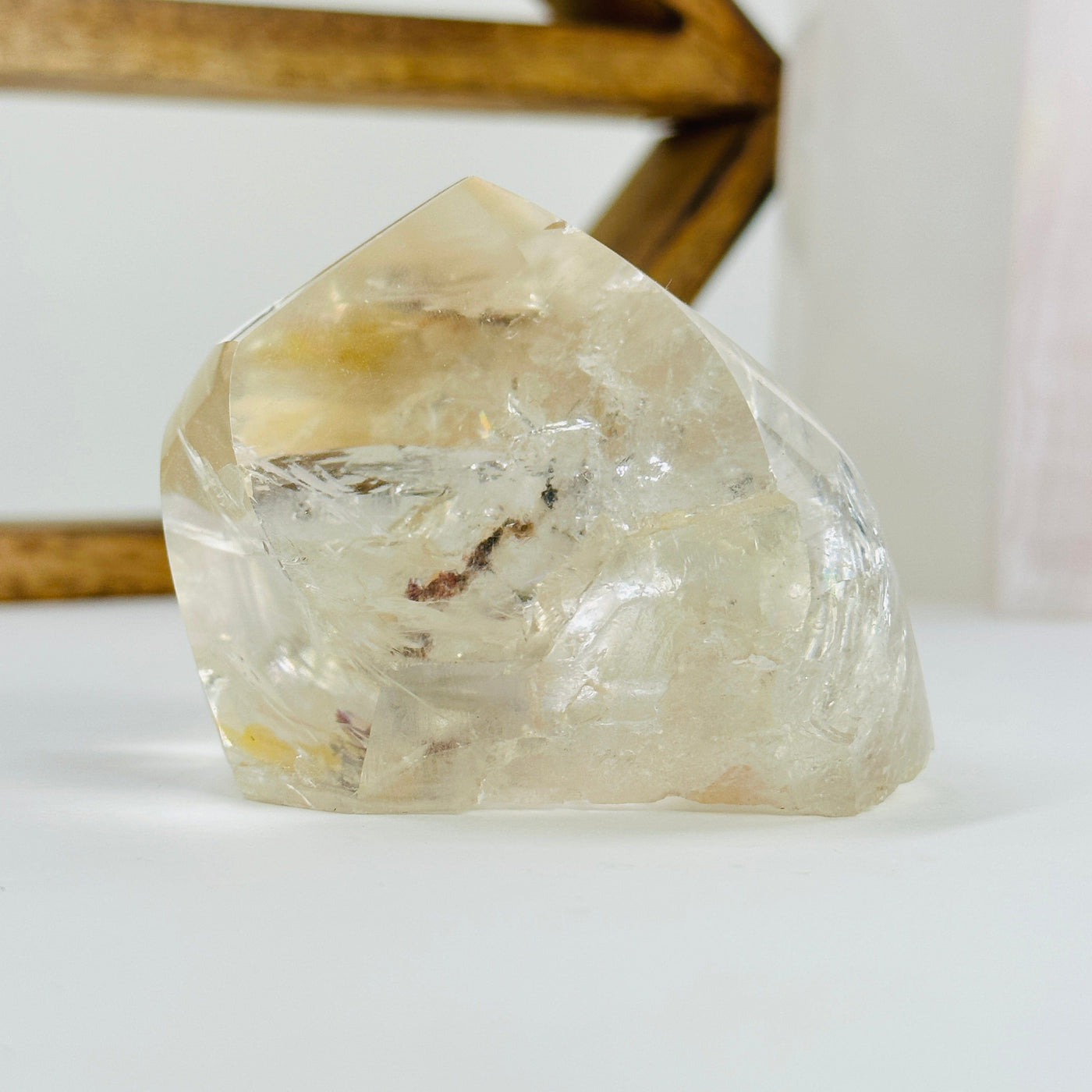 polished crystal quartz with decorations in the background