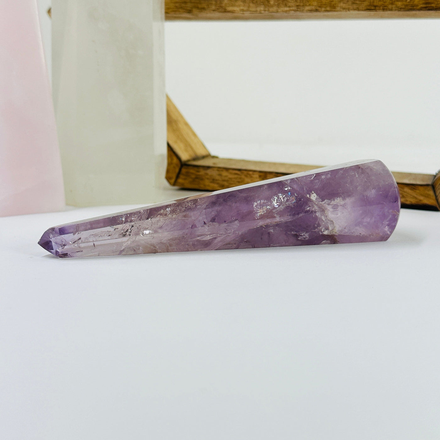 amethyst wand with decorations in the background