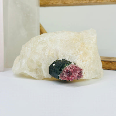 watermelon tourmaline with decorations in the background