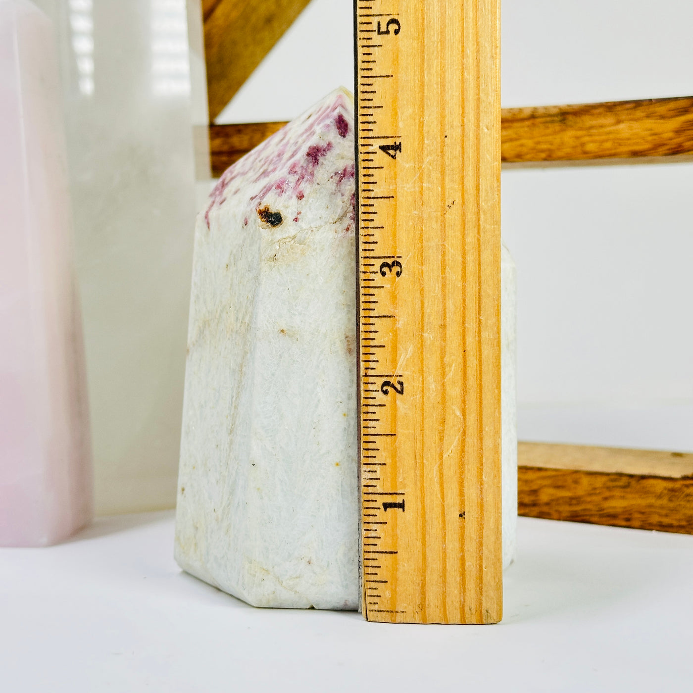 tourmaline point next to a ruler for size reference