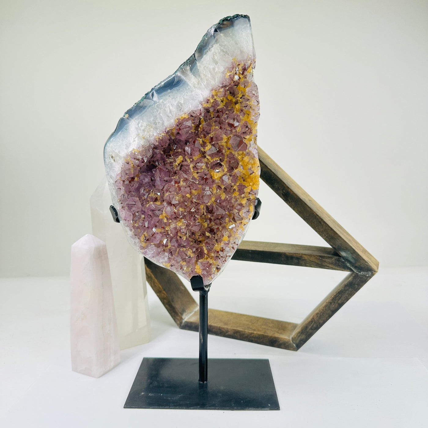 amethyst on metal stand with decorations in the background