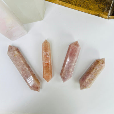  pink amethyst points with decorations in the background