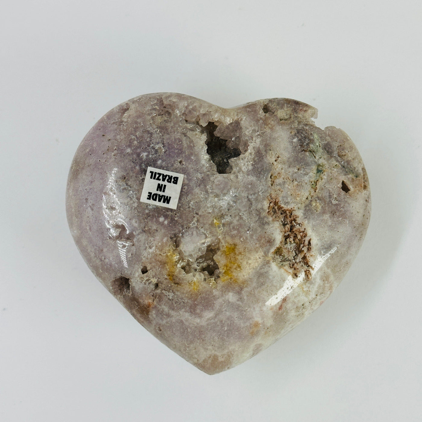 pink amethyst heart with decorations in the background