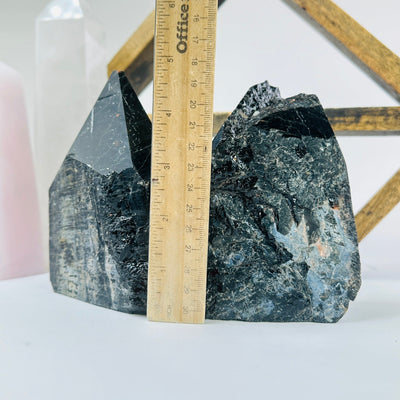 tourmaline points next to a ruler for size reference