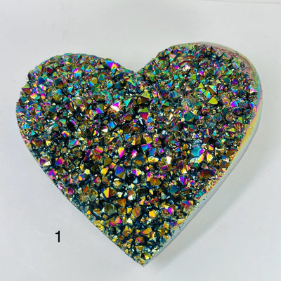 rainbow titanium coated heart with decorations in the background