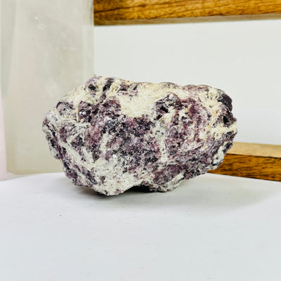 lepidolite with decorations in the background