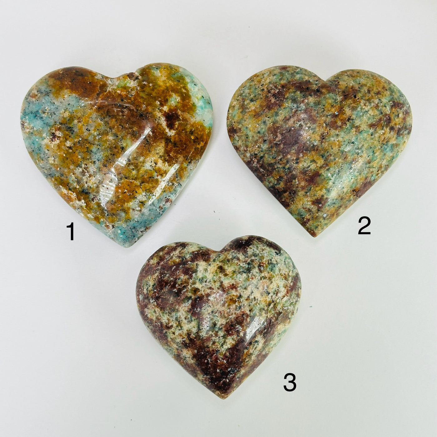 amazonite heart with decorations in the background