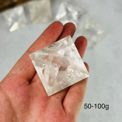 hand holding up 50-100g crystal quartz shape