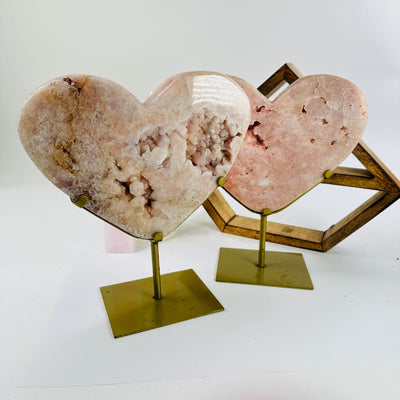 pink amethyst hearts on metal stand with decorations in the background