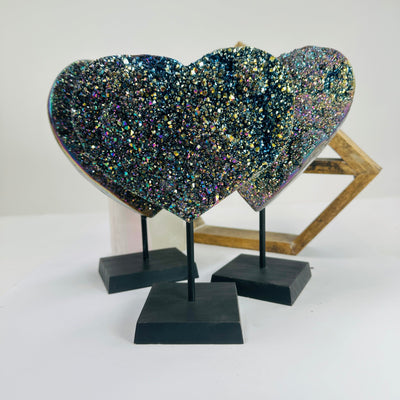 titanium coated heart on stand with decorations in the background