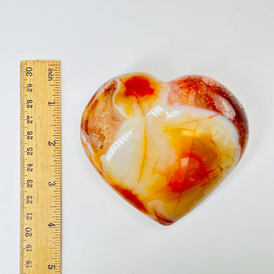 carnelian heart with decorations in the background