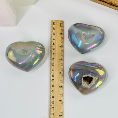 angel aura agate heart next to a ruler for size reference