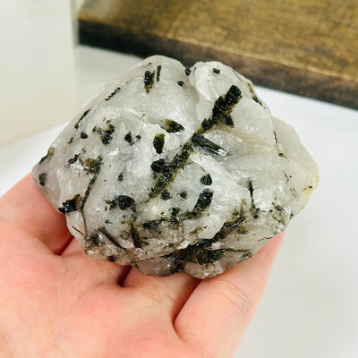 epidote on matrix with decorations in the background