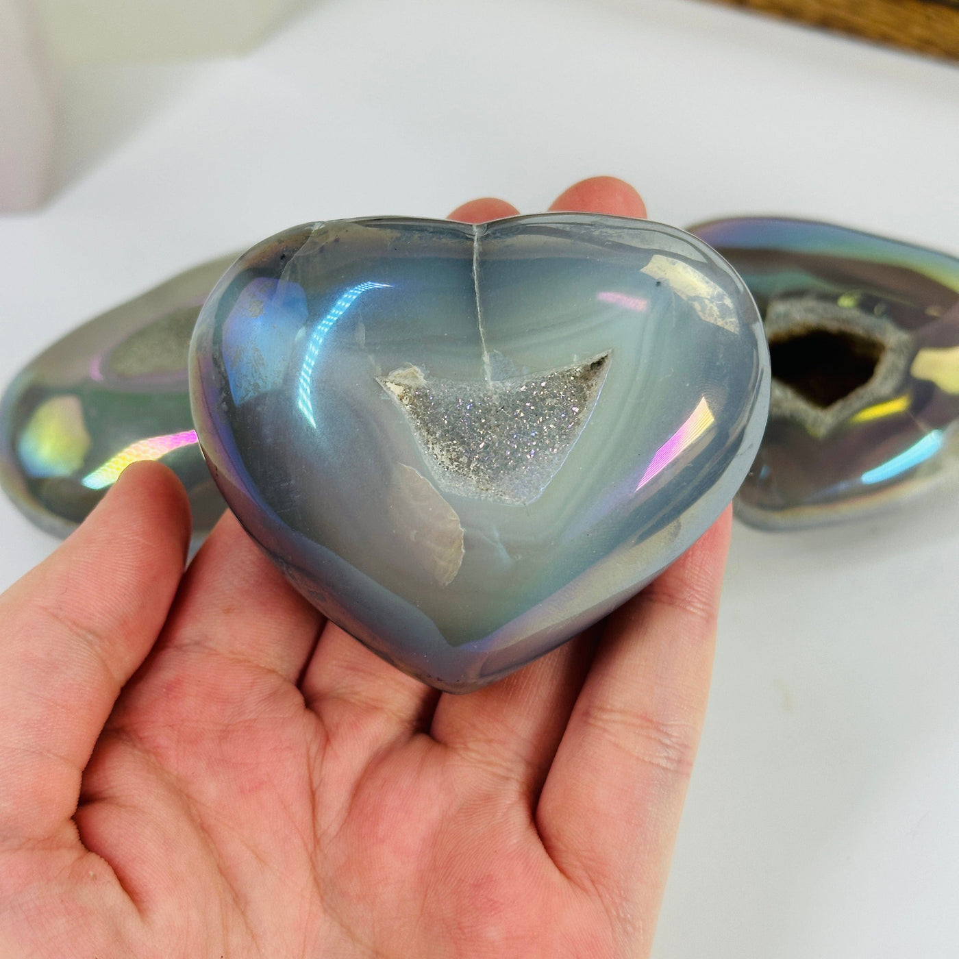 angel aura agate heart with decorations in the background