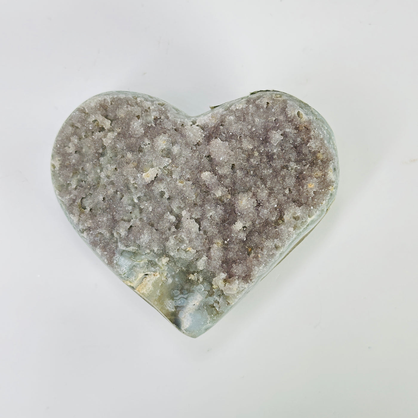 amethyst heart with decorations in the background