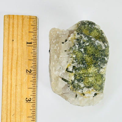 tourmaline next to a ruler for size reference