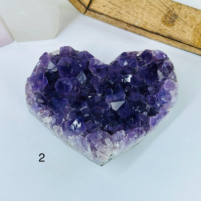 AMTHYST HEARTS WITH DECORATIONS IN THE BACKGROUND