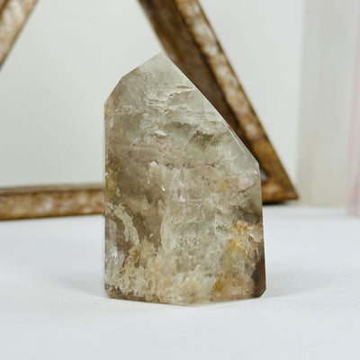 blue amphibole polished point with decorations in the background