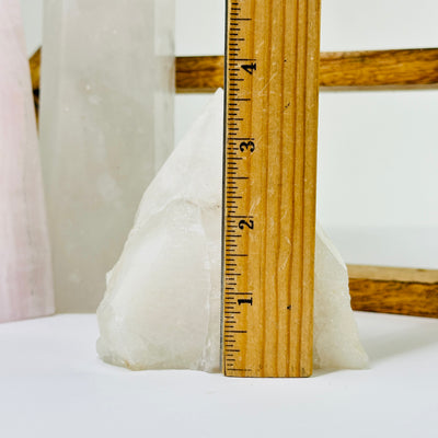 crystal quartz point next to a ruler for size reference