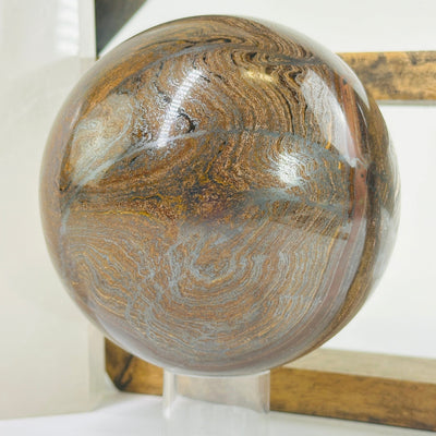 tigers eye sphere with decorations in the background