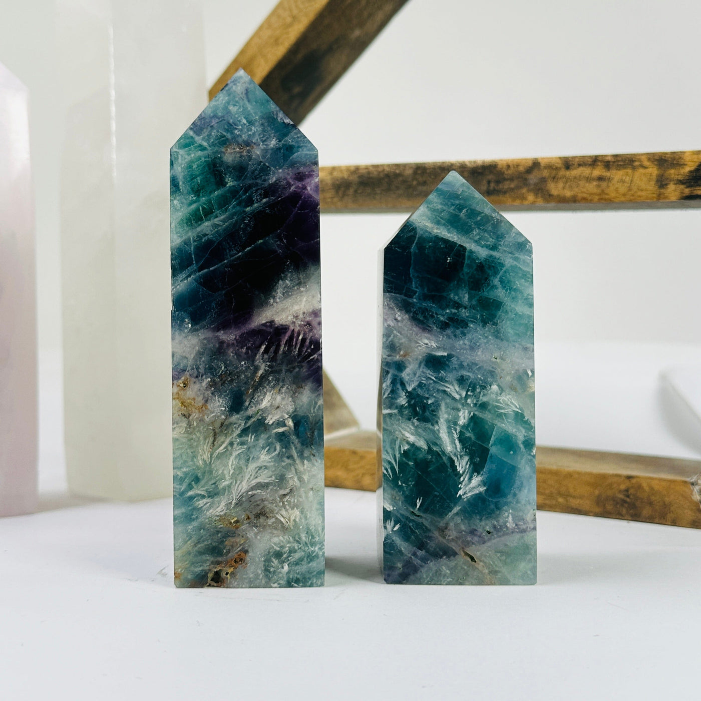 fluorite point with decorations in the background