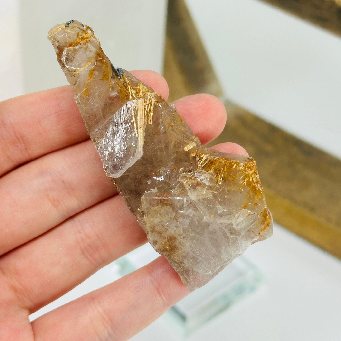 rutilated quartz with decorations in the background