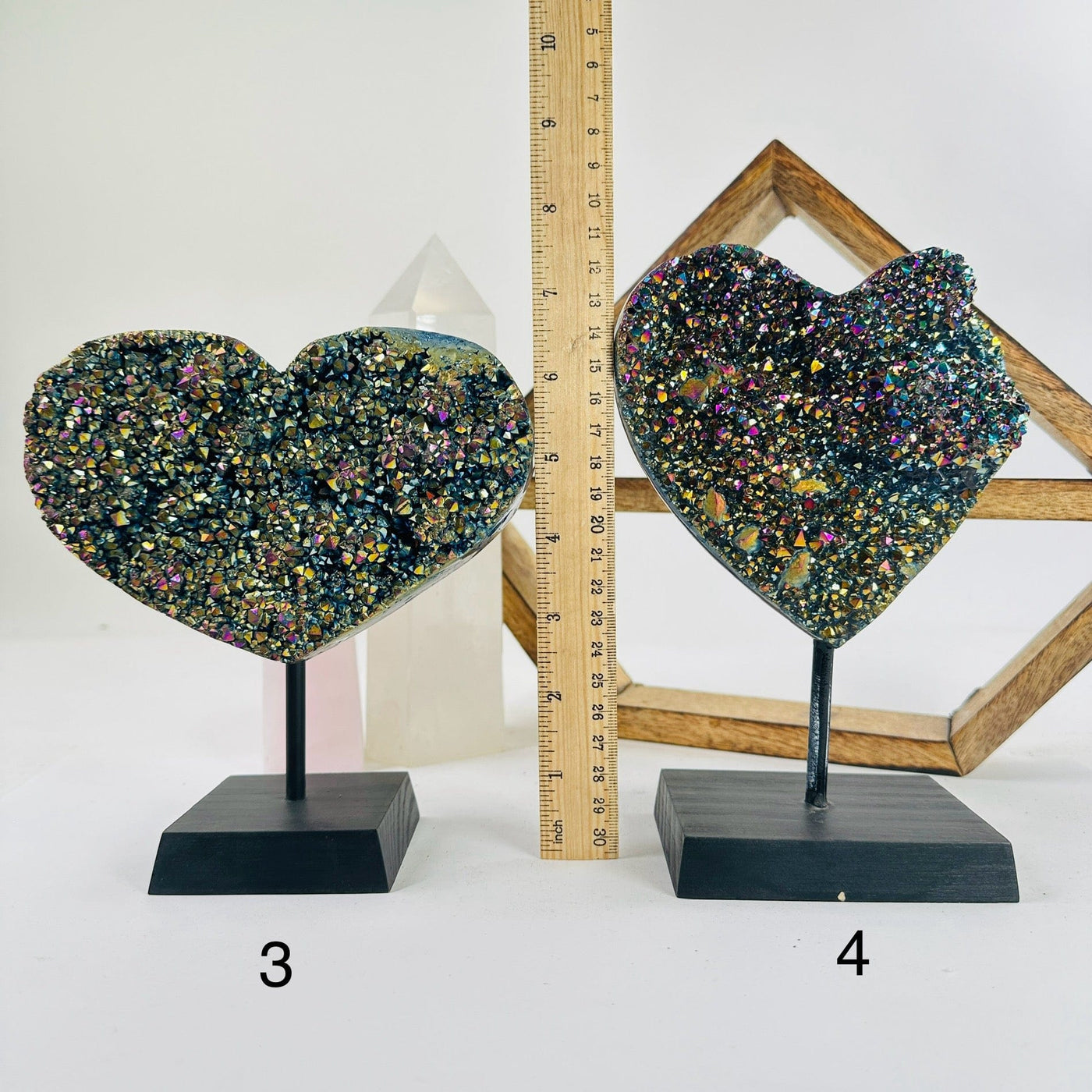 titanium coated hearts on metal stand with decorations in the background