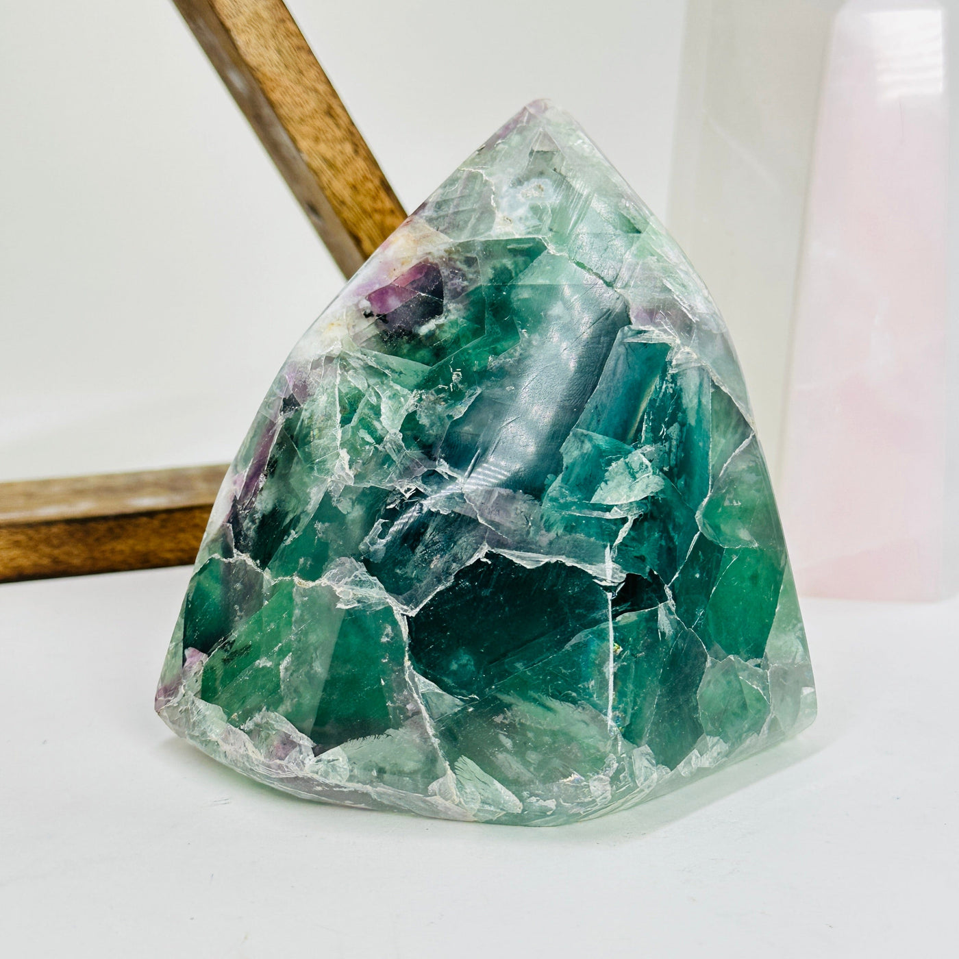 rainbow fluorite cut base with decorations in the background