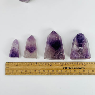 amethyst polished points next to a ruler for size reference