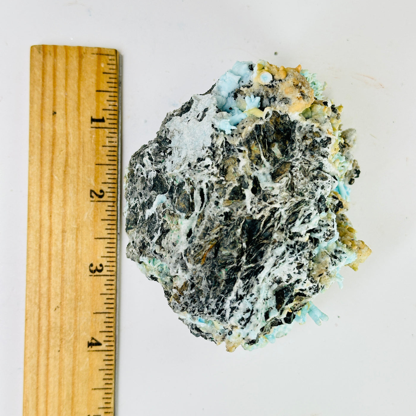 blue aragonite with decorations in the background