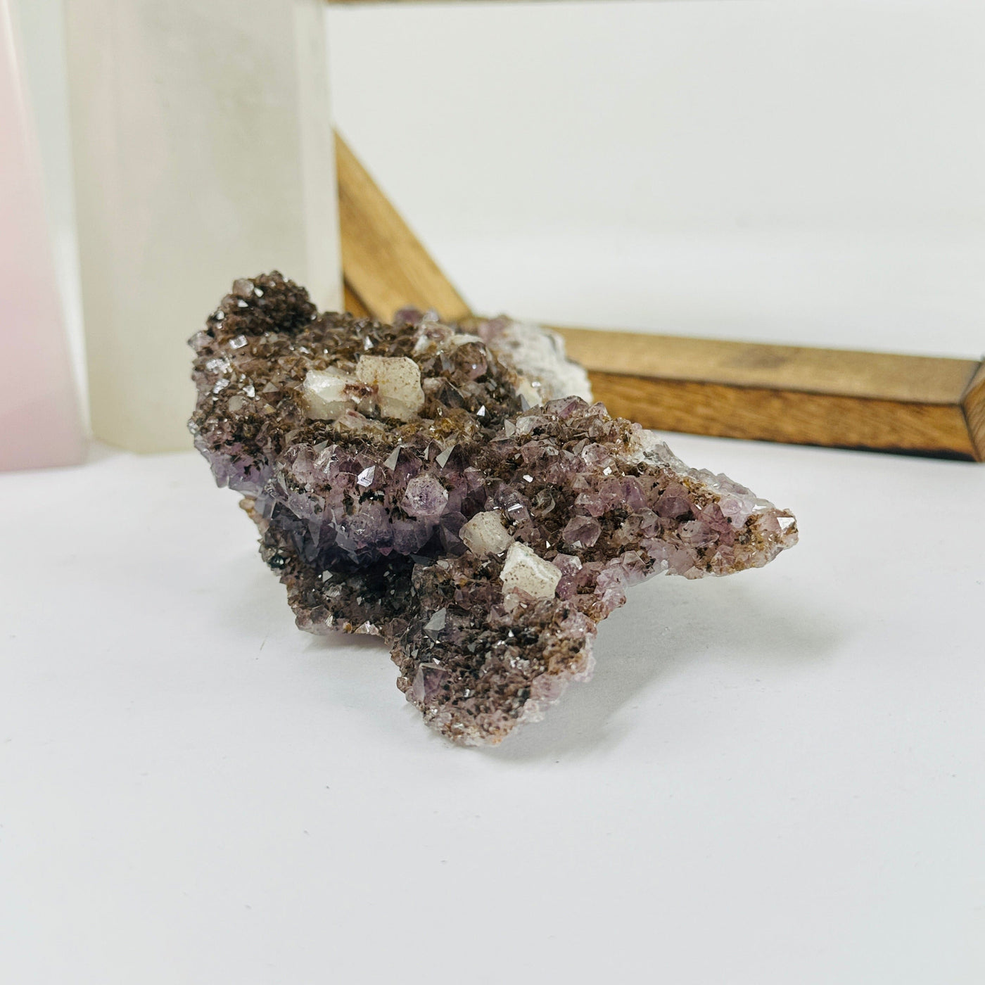 amethyst cluster with decorations in the background