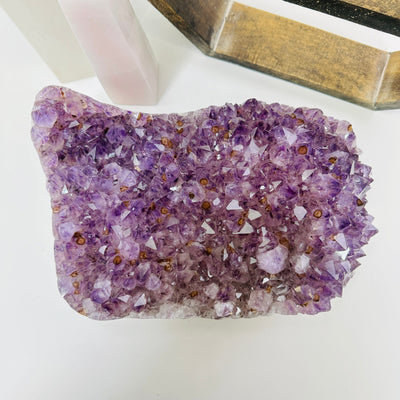 amethyst cluster with decorations in the background