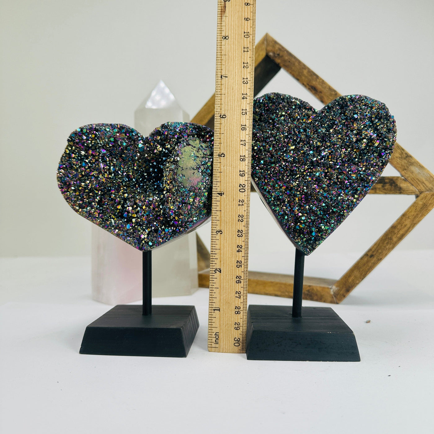 titanium coated heart on stand with decorations in the background