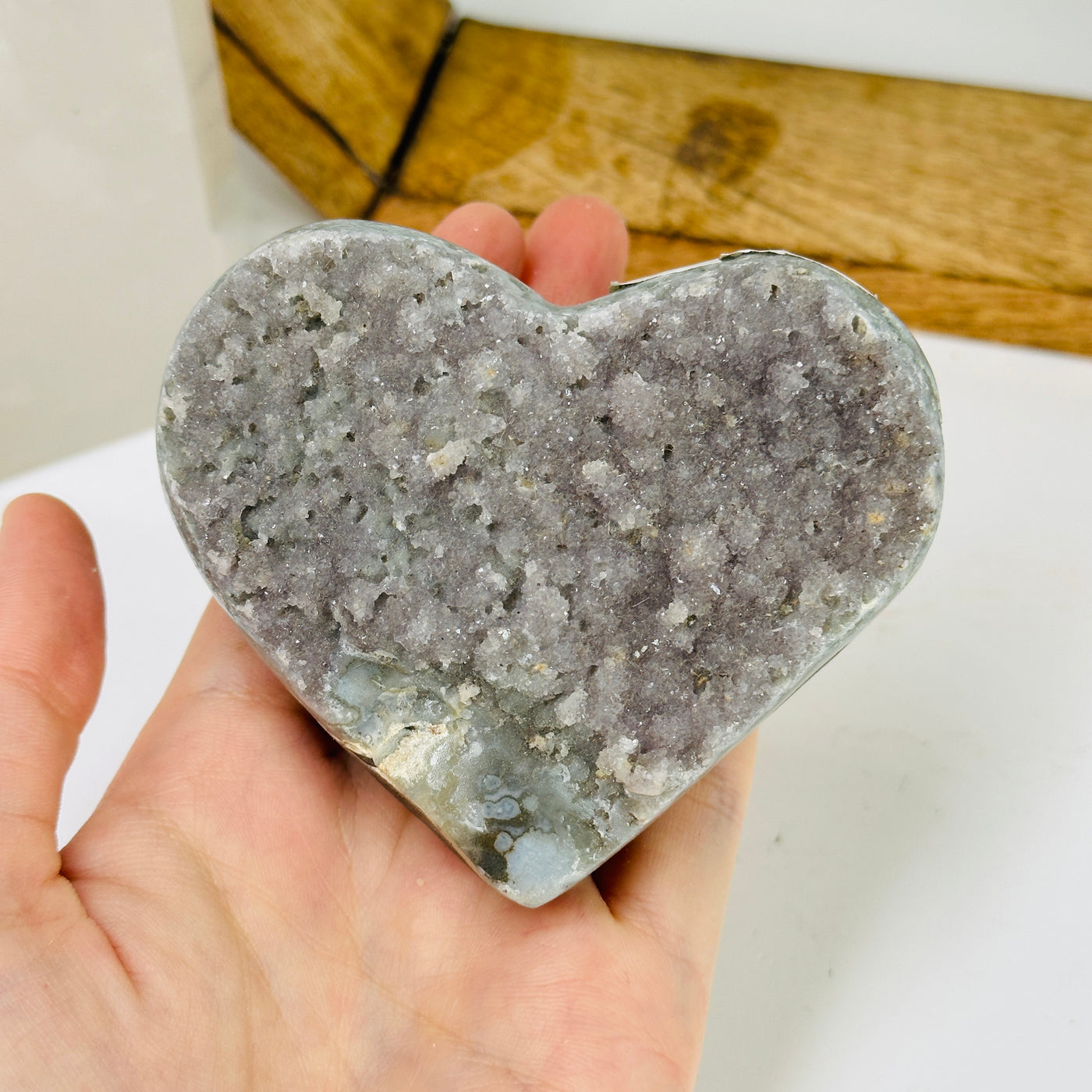 amethyst heart with decorations in the background