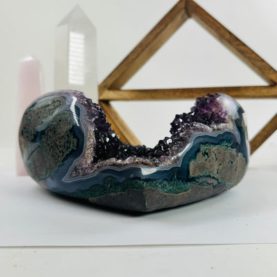 amethyst heart with decorations in the background