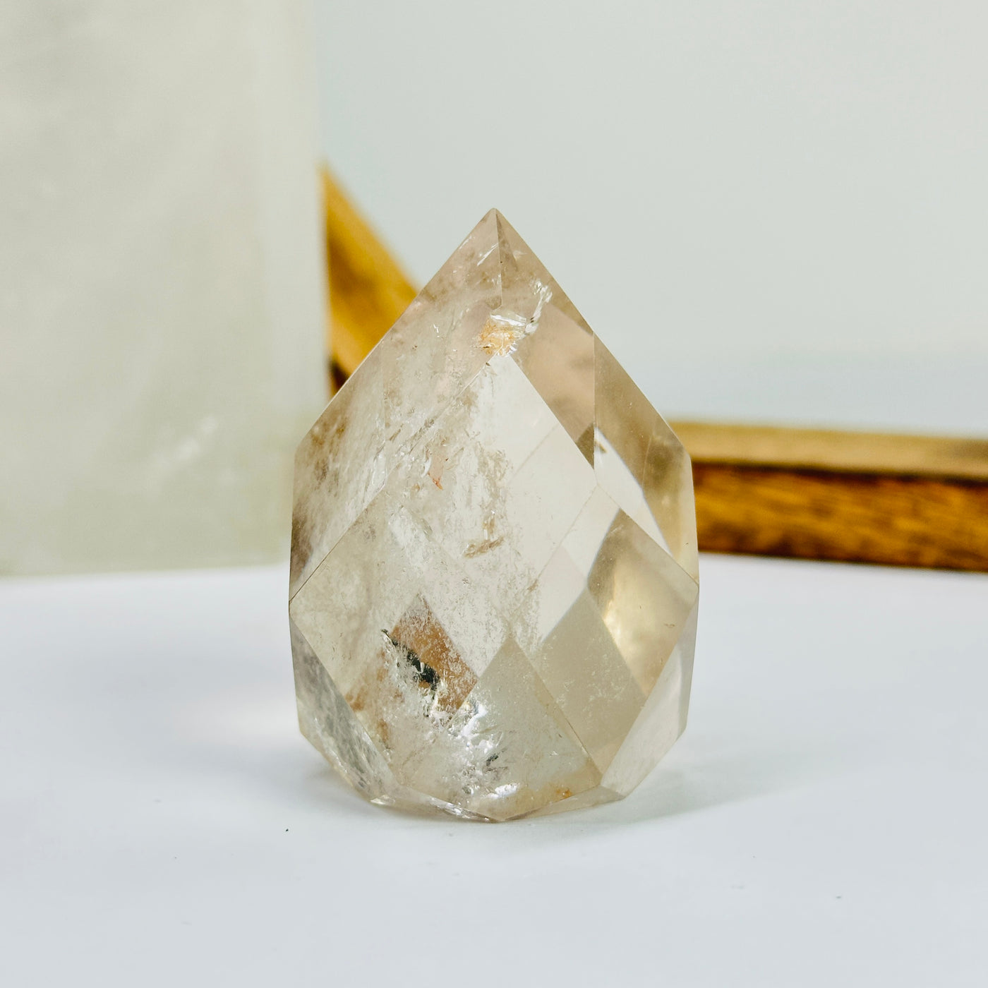 crystal quartz egg with decorations in the background