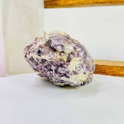 lepidolite with decorations in the background