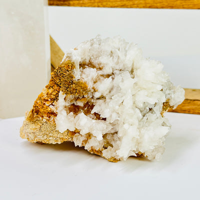 calcite on matrix with decorations in the background