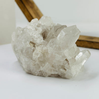 crystal quartz cluster with decorations in the background