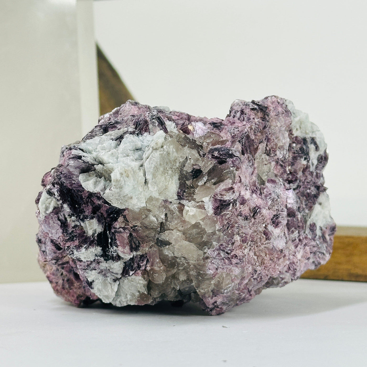 lepidolite cluster with decorations in the background