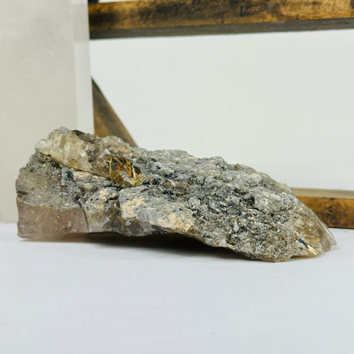 rutile quartz with decorations in the background