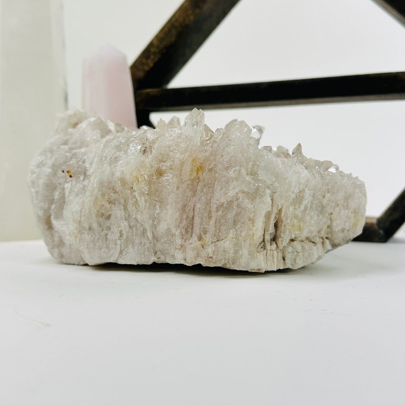 crystal quartz cluster with decorations in the background