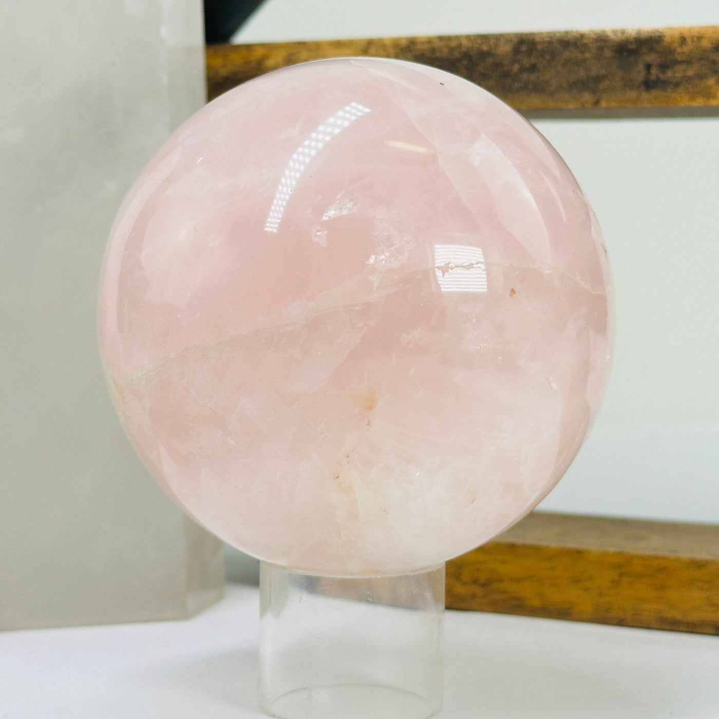 rose quartz sphere with decorations in the background