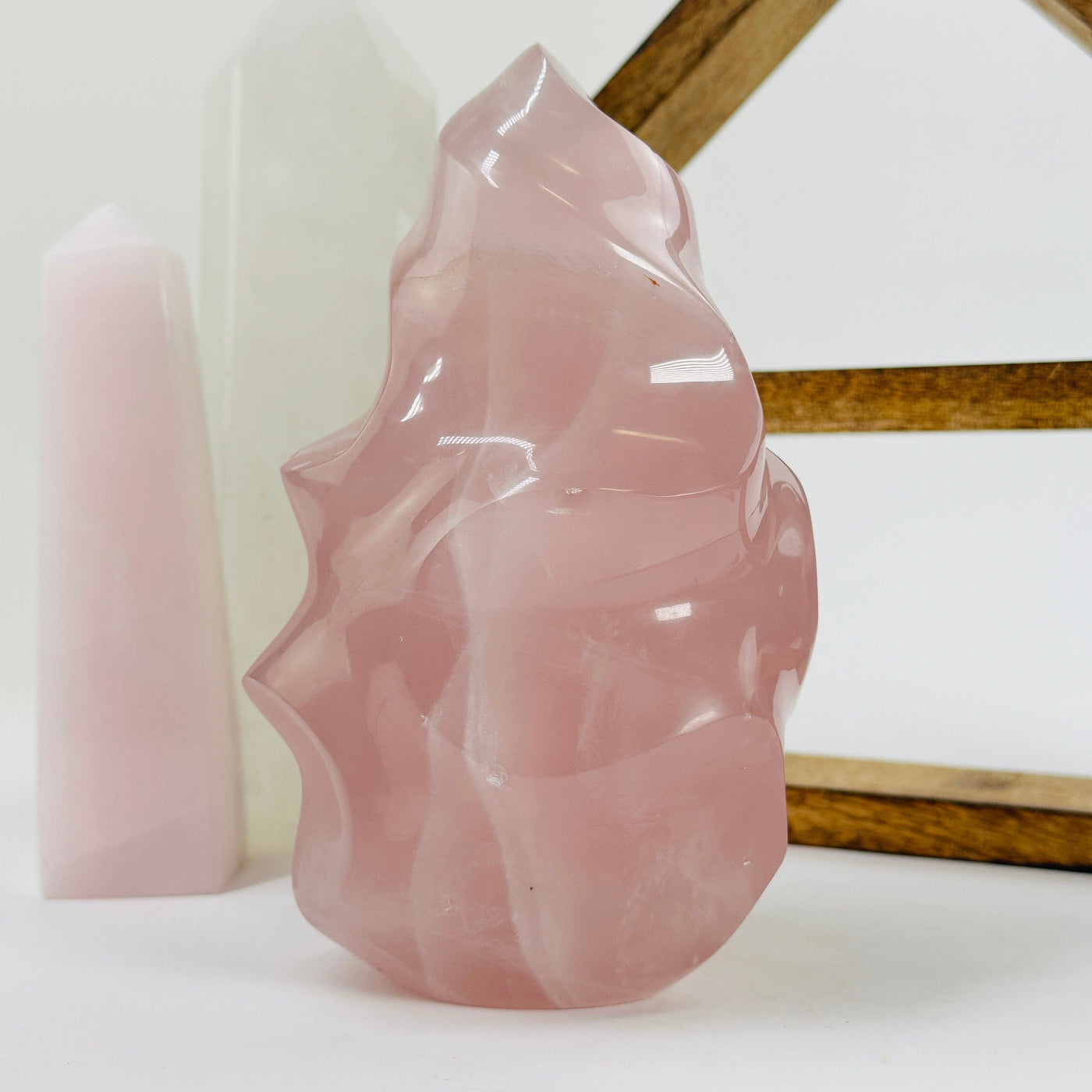 rose quartz flame point with decorations in the background