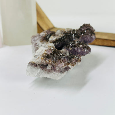 amethyst cluster with decorations in the background